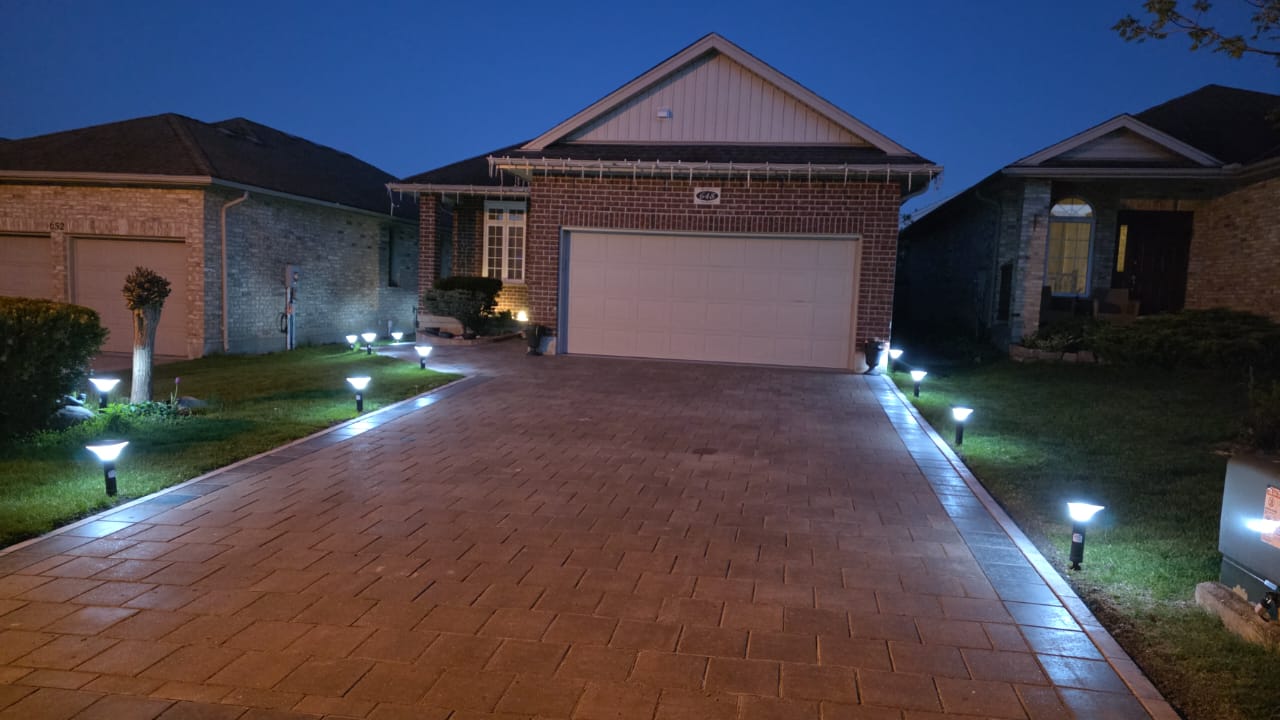 Driveway pathway lights installed at a London Ontario home, illuminated at night