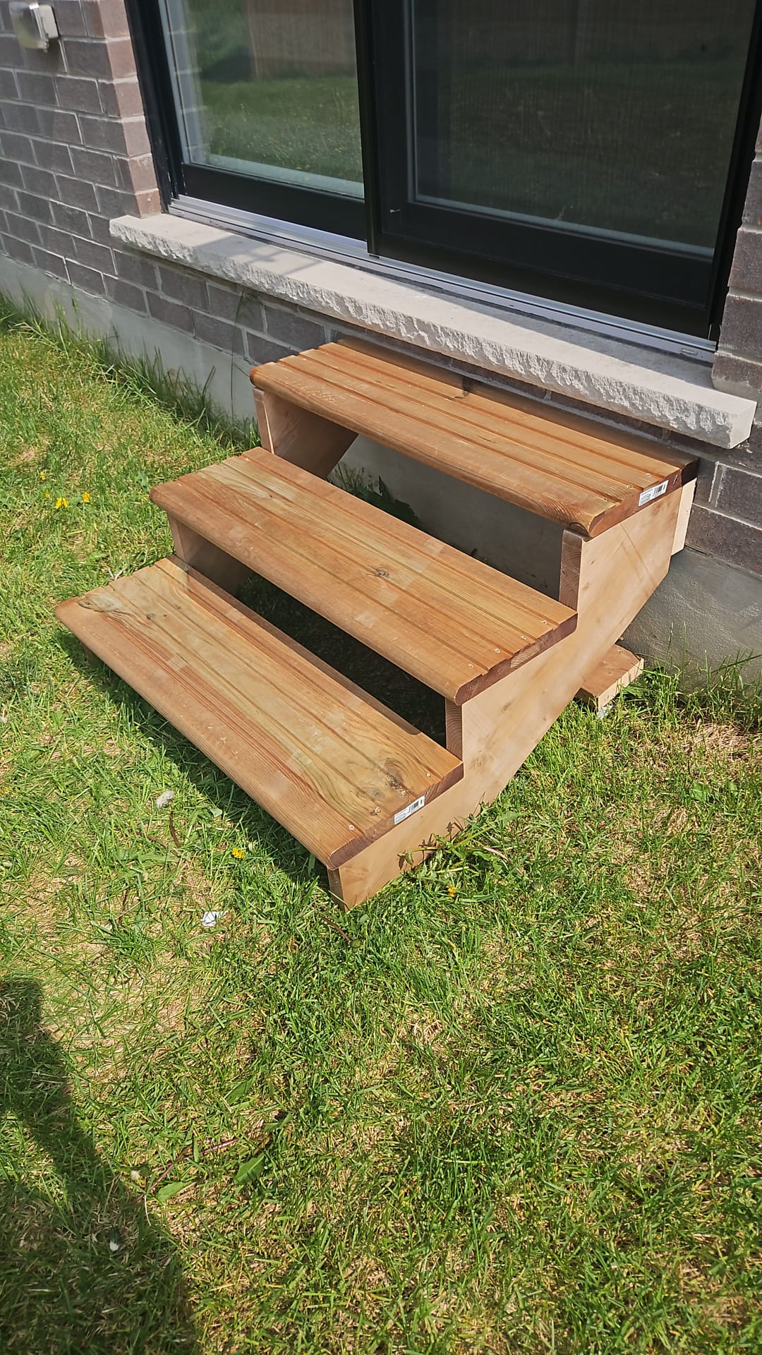 Custom-built wooden steps placed at a residential side door